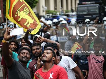 Protesters Take selfy photographs in front of the police brigade during the protest near the president's house in Colombo, Sri Lanka, on May...