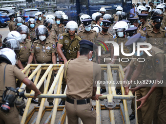 Sri Lanka Police rebuild barricades removed by protesters on May 24, 2022 near the Presidential Palace in Colombo, Sri Lanka. (