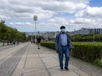 A man wearing a protective mask is seen walking in the vicinity of the Eduardo VII garden. Lisbon, May 23, 2022. Portugal is the European Un...