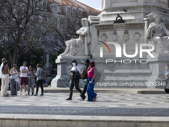 People wearing protective masks are seen walking in the vicinity of Rossio square. May 23, 2022. Portugal is the European Union country with...