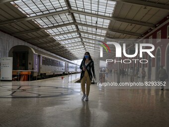 A person wearing a protective mask walks along one of the platforms of Santa Apolonia train station. Lisbon, May 23, 2022. Portugal is the E...