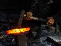 Supardi Seswowarsito, 71, hammers steel as he makes a traditional Javanese Keris daggers at his workshop on May 20, 2022, in Sleman District...