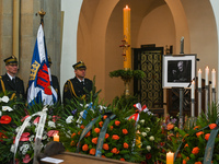Image of Jerzy Trela, a Polish actor, seen next to the urn with Trela's ashes surrounded by flowers and wreaths during a funeral mass at the...