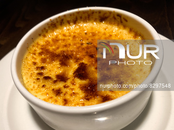 Creme brulee dessert is seen at a restaurant table in this illustration photo taken in Krakow, Poland on May 22, 2022. (