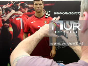 A fan take a picture of the Cristiano Ronaldo waxwork on display at the Cristiano Ronaldo traveling museum in Lisbon, on October 6, 2015. ( 