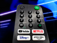 A detail of TV remote control with streaming platform buttons is seen in a store in Krakow, Poland on May 30, 2022. (