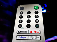 A detail of TV remote control with streaming platform buttons is seen in a store in Krakow, Poland on May 30, 2022. (