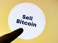 Selling Bitcoins button is seen on ATM in Krakow, Poland on May 30, 2022. (