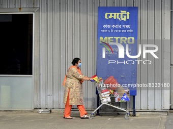 A woman with her shopping trolley walks past a Metro Cash And Carry wholesale retail market in Kolkata, India, 01 June, 2022. German retaile...
