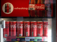 A refrigerator with cans of Coca-Cola on a coffee shop in the center of Athens, Greece on June 1, 2022. (