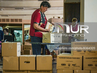 A woman takes humanitarian aid in the distribution center of Kostiantynivka. Supply of some food and goods stopped because the combats in ma...