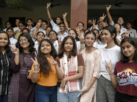 Students of St. Mary's English High School celebrate after their student Ashlesha Sarma (M) stood 7th rank in the HSLC class 10 examination,...