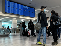 Travelers wearing face masks during the COVID-19 pandemic at Toronto Pearson International Airport in Mississauga, Ontario, Canada, on May 0...