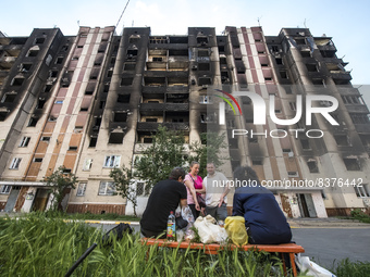 Local residents near  an apartment building destroyed during Russia's invasion of Ukraine  in Irpin town near Kyiv, Ukraine, June 09, 2022...
