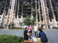 Local residents near  an apartment building destroyed during Russia's invasion of Ukraine  in Irpin town near Kyiv, Ukraine, June 09, 2022...