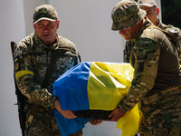 The Armed Forces of Ukraine are carrying the coffin of the dead Ukrainian serviceman in Poltava, Ukraine, on June 10, 2022.  (