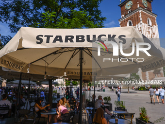 Starbucks Coffee shop summer garden at the Main Square in Krakow, Poland on June 6th, 2022. (