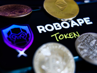 RoboApe Token logo displayed on a phone screen and representation of cryptocurrencies are seen in this illustration photo taken in Krakow, P...