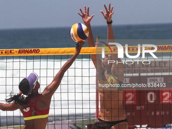 Indonesia’s Siam Yokebed Purari (left) knocks the ball to the Australia side during the Sepanjang Beach Volley Ball Asia Pacific Tournament...