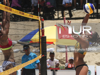 Australias's Aracho Del Solar Maria smash the ball to the Indonesia side againts Siam Ayu Cahyaning during the Sepanjang Beach Volley Ball A...