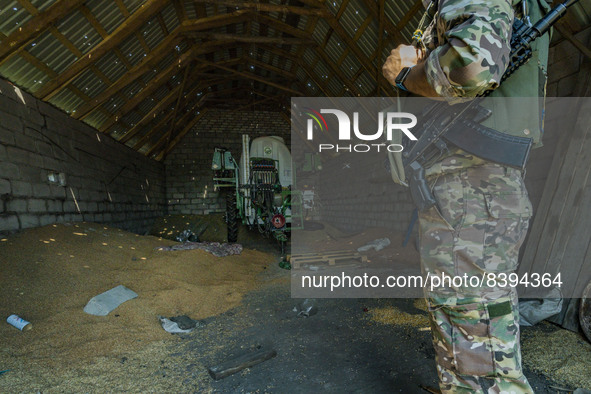A ukrainian soldier check an empty barn near the frontline of the Zaporizhzhia province, Ukraine. Harvest can not be collected in the area b...