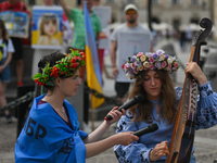 Svetlana Nikonorova, a Ukrainian singer and bandura player, performs a song during the protest.Members of the local Ukrainian diaspora, war...