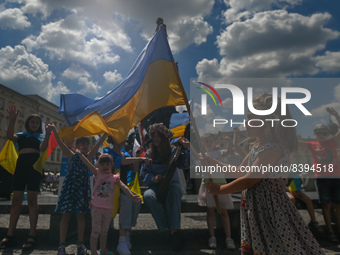 Svetlana Nikonorova, a Ukrainian singer and bandura player, surrounded by children performs a song during the protest.Members of the local...