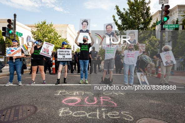 Protesters block a street touside the Supreme Court during a demonstration against the leaked decision that would overturn Roe v. Wade.  Ove...