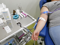 A Ukrainian woman donates blood during the World Blood Donor Day (WBDD), amid Russia's invasion of Ukraine, at a transfusiology department i...