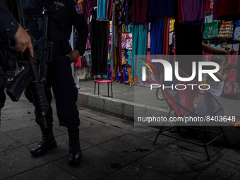 Police officers search a local market in downtown San Salvador during a patrolling operation on April 25, 2022 in San Salvador, El Salvador....