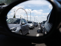 Cars standing in a traffic jam are reflected in the car's mirror in Krakow, Poland on June 15, 2022. (