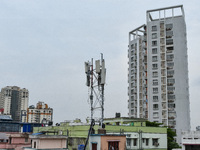 A mobile network tower is seen amidst high rises in Kolkata , India , on 16 June 2022 . India will auction 5G airwaves beginning on 26th Jul...