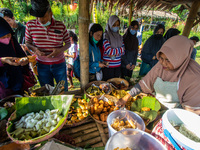 Tourists visit the Sawahan Market, a traditional snack market in Kalongan Village, Ungaran, Central Java, Indonesia on June 19, 2022. (