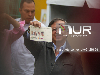 Left-wing presidential Candidate Gustavo Petro shows his vote to the media during the voting rally for the presidential runoffs between left...