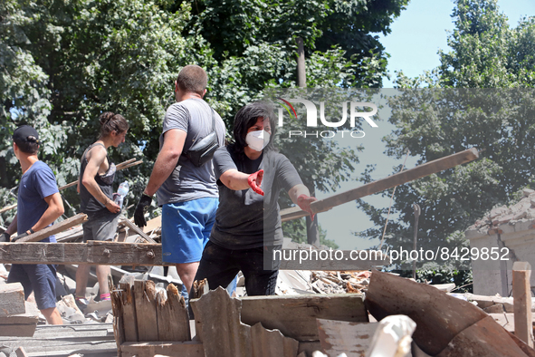 LIUBOTYN, UKRAINE - JUNE 20, 2022 - People remove the rubble at the Liubotyn Railway Transport Lyceum which hosted a humanitarian aid wareho...