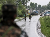 A CRPF Trooper stands alert near a Gunfight site in which 2 militants were killed in Tulibal Sopore District Baramulla Jammu and Kashmir Ind...