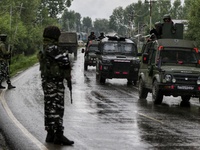 Security forces leave in their vehicles after Gunfight in Tulibal Sopore District Baramulla Jammu and Kashmir India on 21 June 2022. 2 Milit...