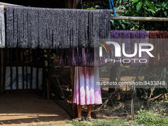 A woman is drying yarn at the traditional weaving workshop at Troso village in Jepara, Central Java Province, Indonesia on June 21, 2022. Te...