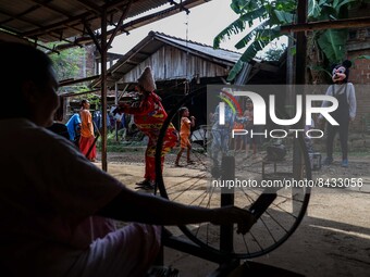 A woman working with handmade wooden frames for spinning thread at the traditional weaving workshop at Troso village in Jepara, Central Java...