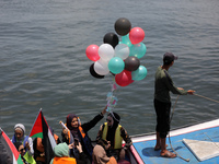 Palestinians throw the political letters into the sea as they take part in a rally, in the Gaza port, on June 22, 2022. Home to more than tw...