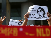 Protesters hold placards with pictures of Aung San Suu Kyi during a demonstration against the military coup in Yangon, Myanmar on February 7...