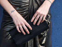 American actress Riley Keough wearing YSL (clutch detail) arrives at the Los Angeles Premiere Of Amazon Prime Video's 'The Terminal List' Se...