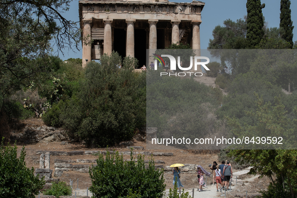 Tourists visit the temple of Hephaestus  during a heatwave in Athens, Greece, on June 23, 2022 