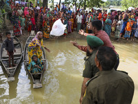 Bangladeshi Ansar VDP soldier distribute relief material to flood affected people in Sylhet, Bangladesh on June 24, 2022. (