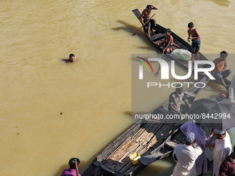 A flood affected man swim to flooded water for collect medicine and relief material for flood affected people at Sylhet, Bangladesh on June...