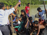 A local NGO workers distribute medicine and relief material to flood affected people in Sylhet, Bangladesh on June 24, 2022. (