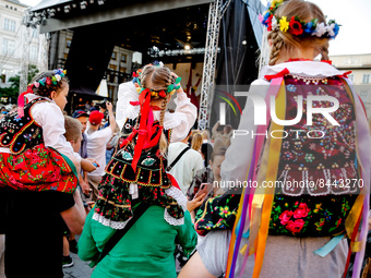 Girls dressed in Krakow folklore dresses participate in a parade of Lajkonik, a folklore tradition connected with history of Krakow in an Ol...