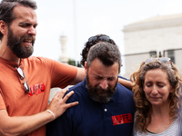 Members of Bound 4 People, a Christian group, break down while praying after the Supreme Court issued its opinion on Dobbs v. JWHO.  The opi...
