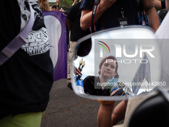 Washington, DC, area pro-choice activist is reflected in the mirror of a Capitol Police motorcycle prior to the Supreme Court's announcement...