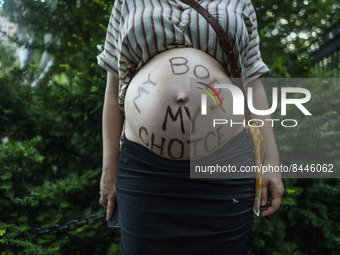 My body, my choice appears on a pregnant womans stomach during a protest against the Supreme Courts decision to overturn Roe V. Wade on Frid...